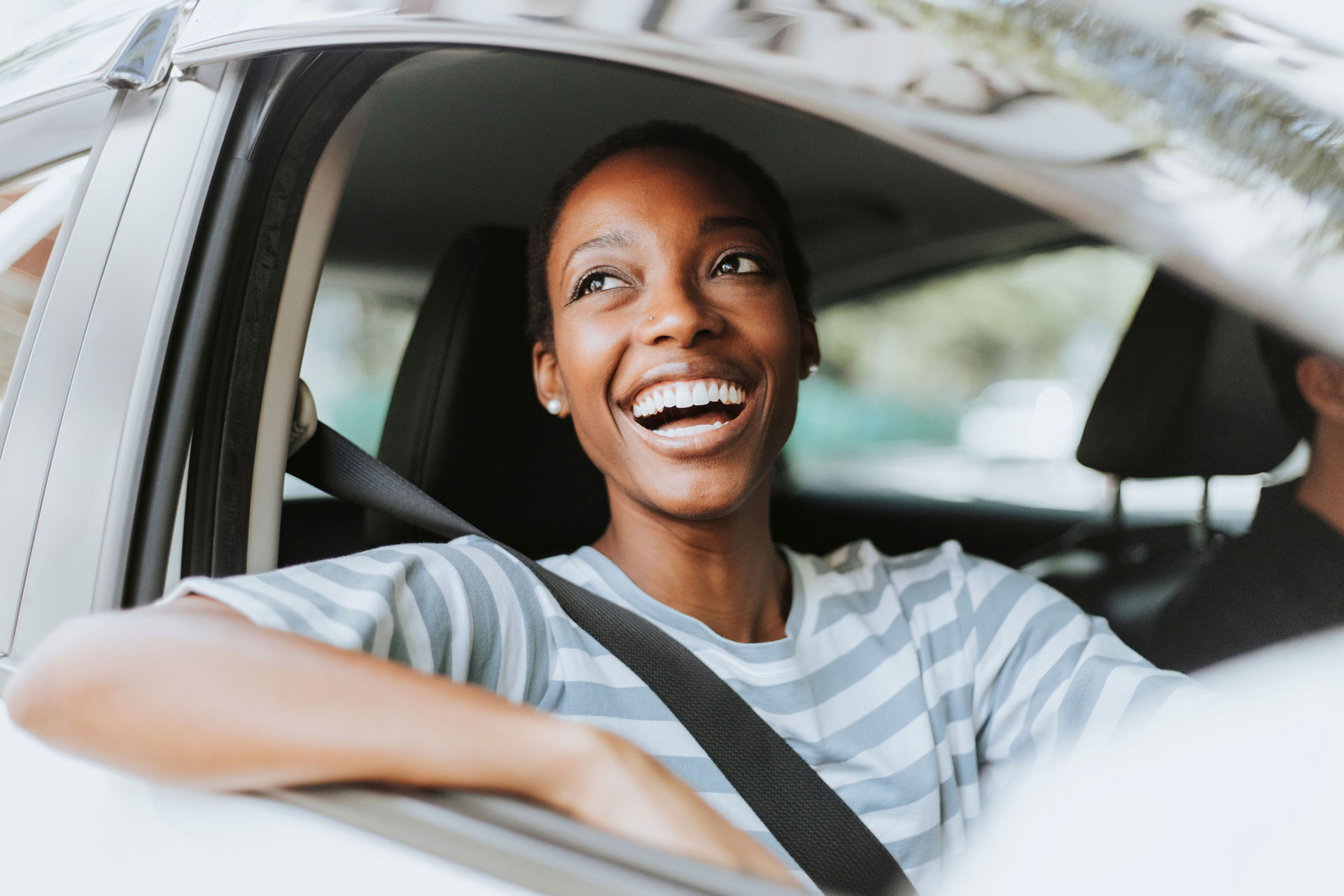 Woman smiling as she drives her car