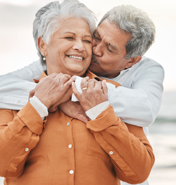 Older couple embracing and smiling