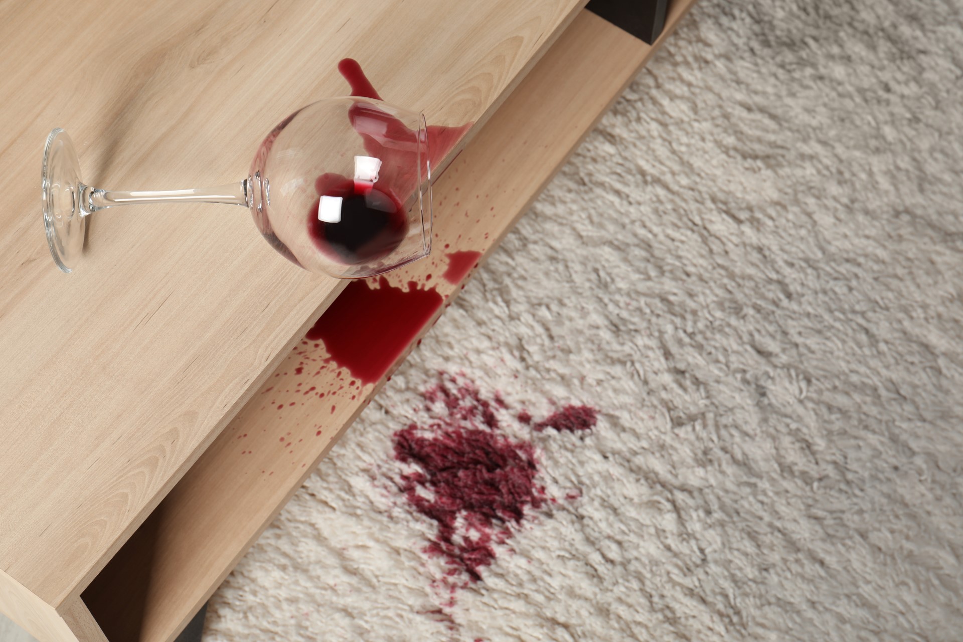 Red wine spilled on a cream carpet