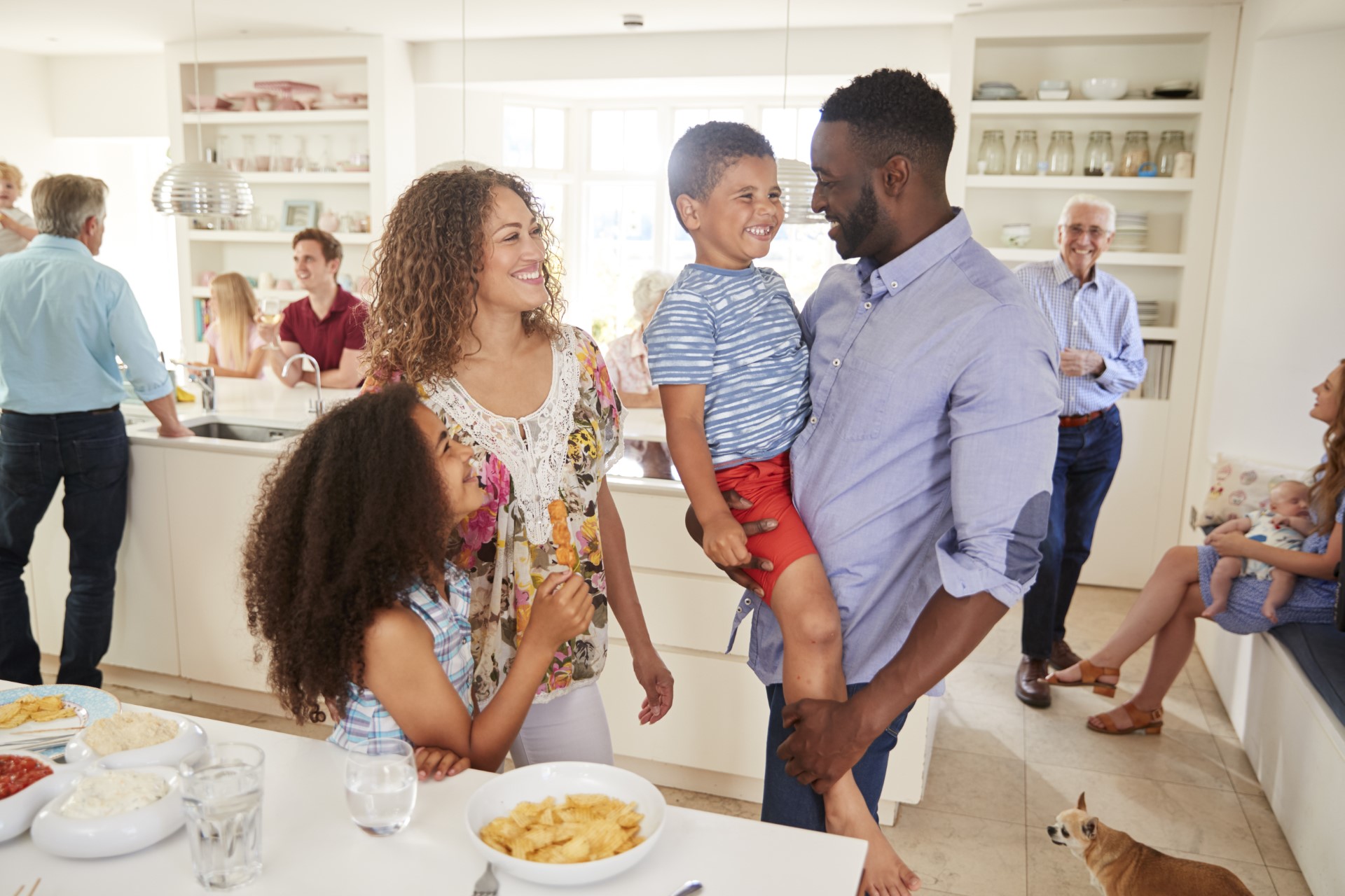 Family and friends gathered in a kitchen at home