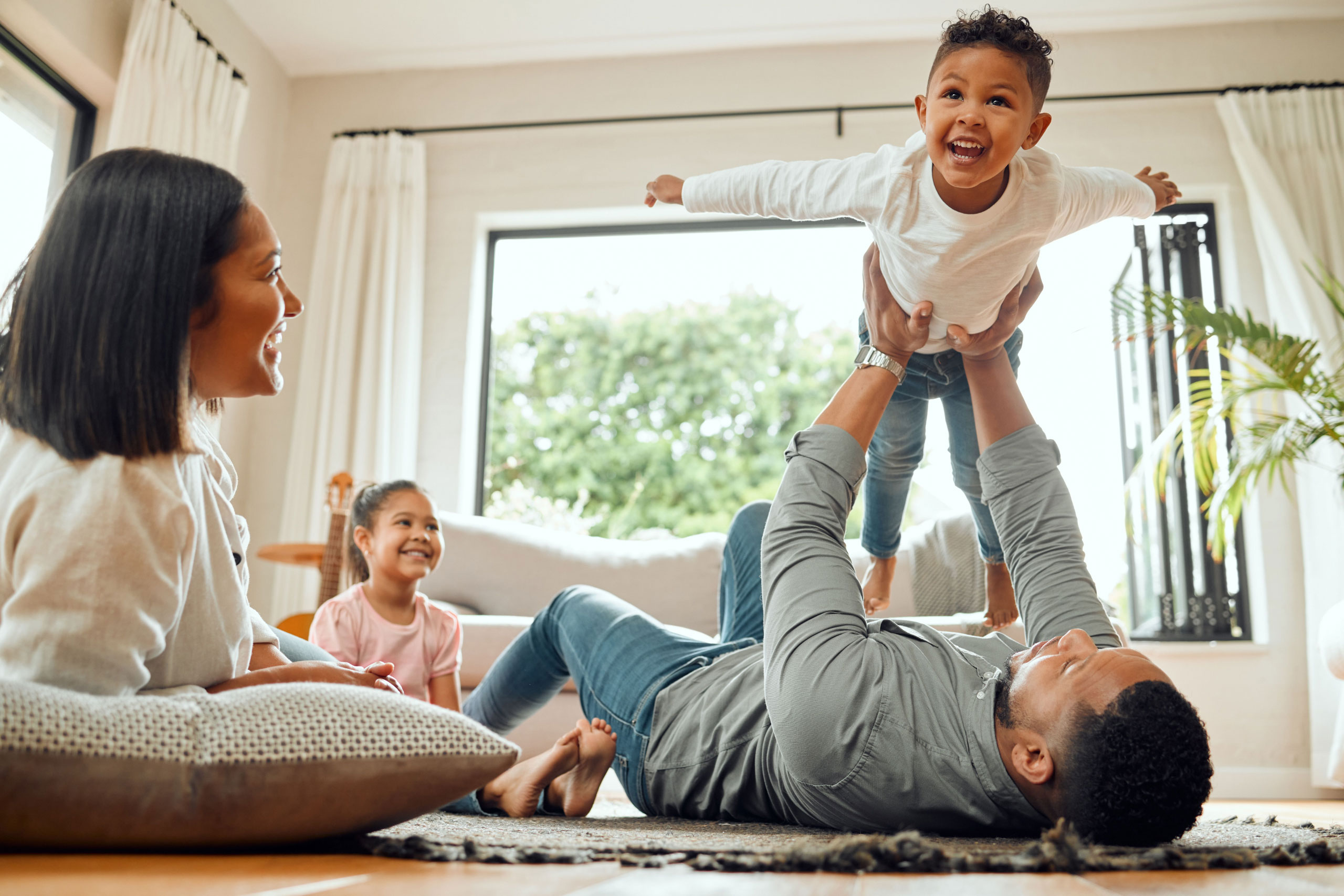 Parents playing with their children at home
